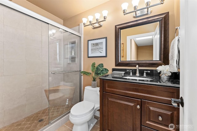 full bath featuring vanity, tile patterned floors, toilet, and a stall shower