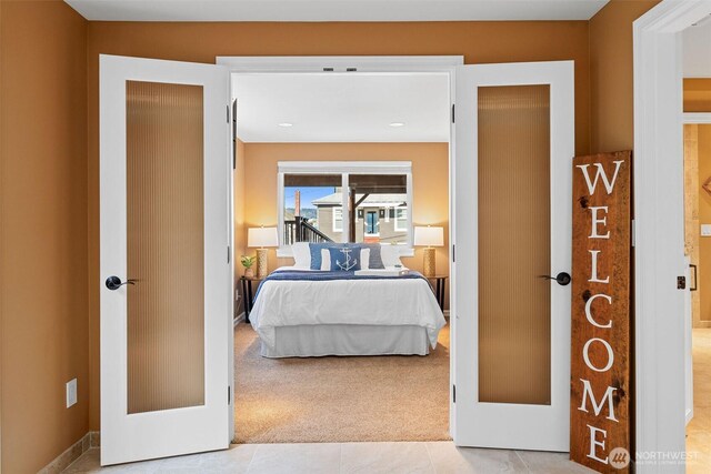 tiled bedroom featuring carpet flooring and french doors