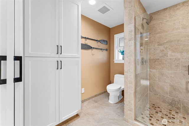 bathroom with visible vents, toilet, a stall shower, tile patterned flooring, and baseboards