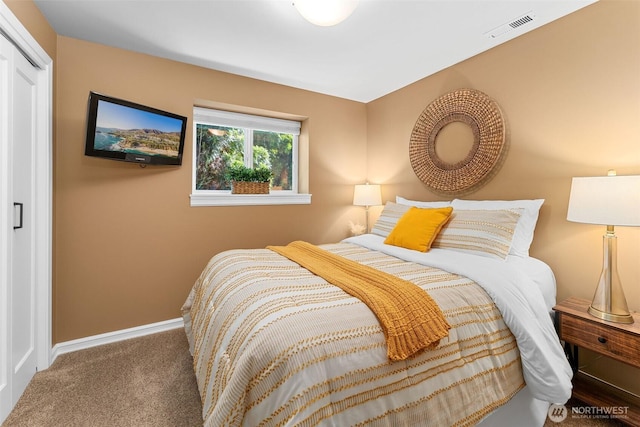 carpeted bedroom featuring visible vents and baseboards