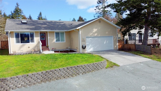 ranch-style house with concrete driveway, an attached garage, fence, and a front yard