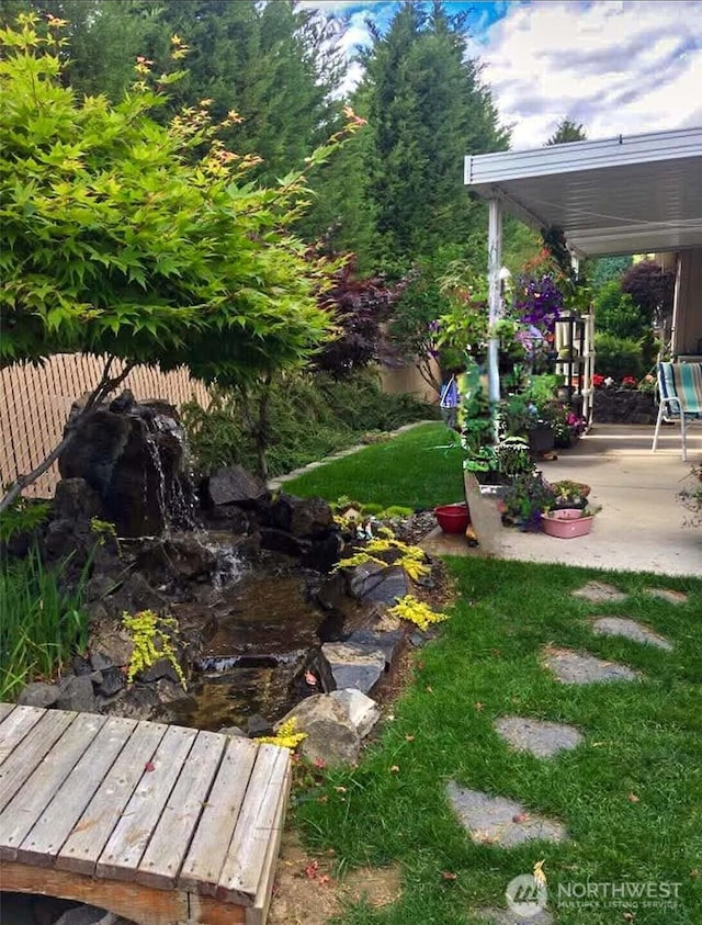 view of yard featuring a patio area and fence