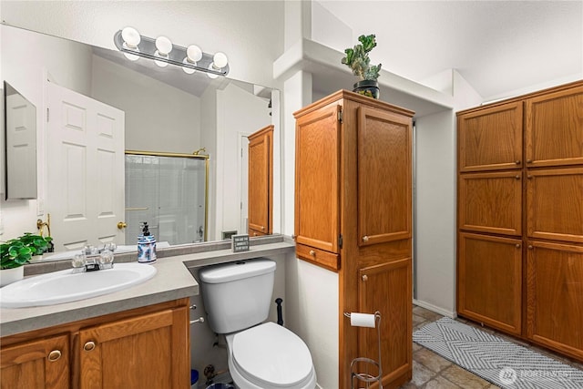 full bath with vanity, toilet, a shower with shower door, and tile patterned flooring