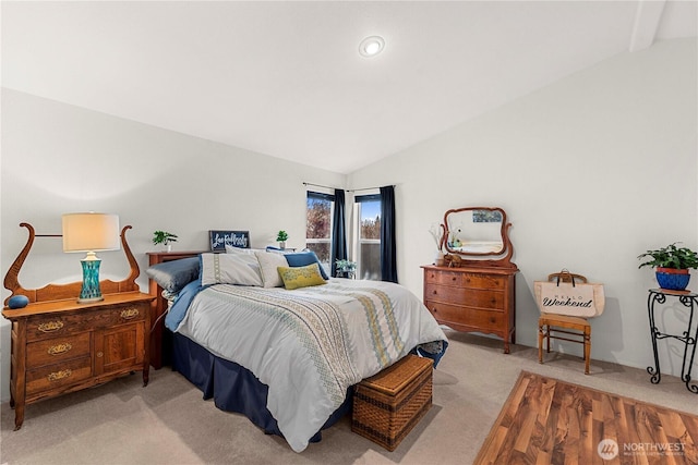 bedroom with light carpet and vaulted ceiling