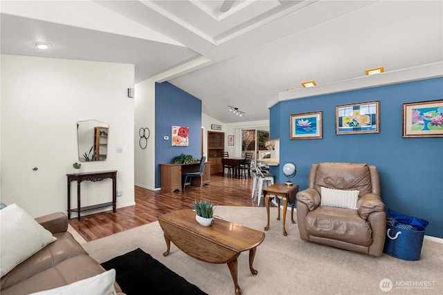 living room featuring vaulted ceiling, wood finished floors, and baseboards