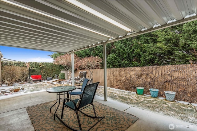 view of patio with outdoor dining space and fence