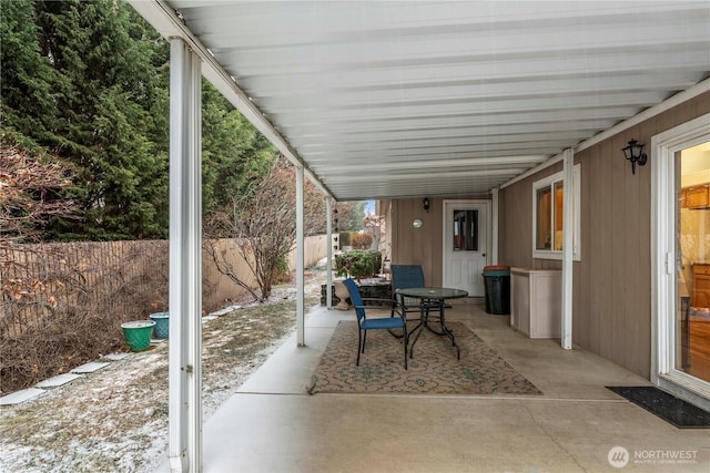 view of patio with outdoor dining space and fence