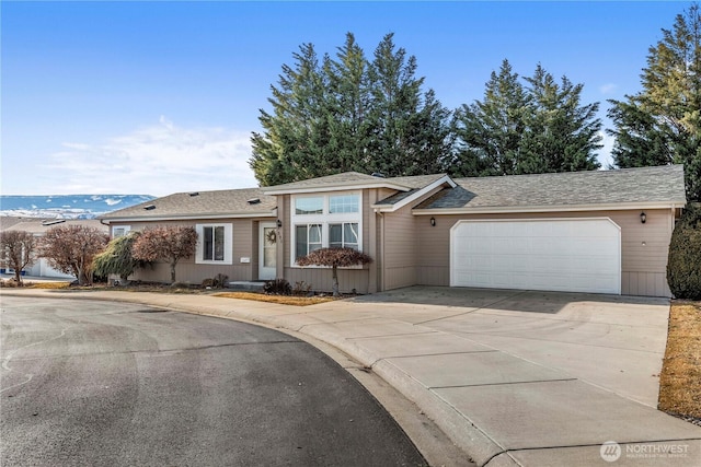 single story home with an attached garage and concrete driveway