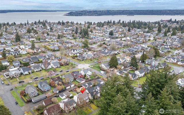 birds eye view of property with a residential view and a water view