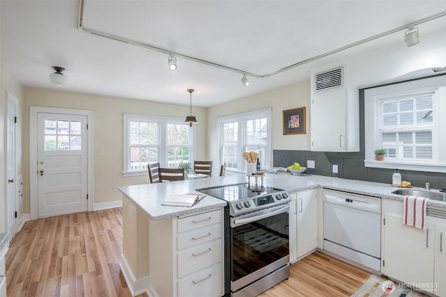 kitchen featuring white cabinetry, stainless steel electric range, a peninsula, white dishwasher, and light wood finished floors