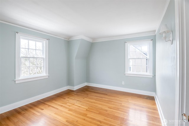 unfurnished room with light wood-type flooring, baseboards, and ornamental molding