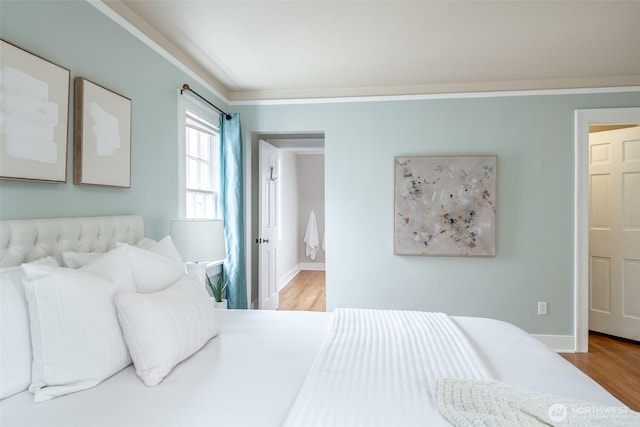 bedroom featuring baseboards and light wood-type flooring