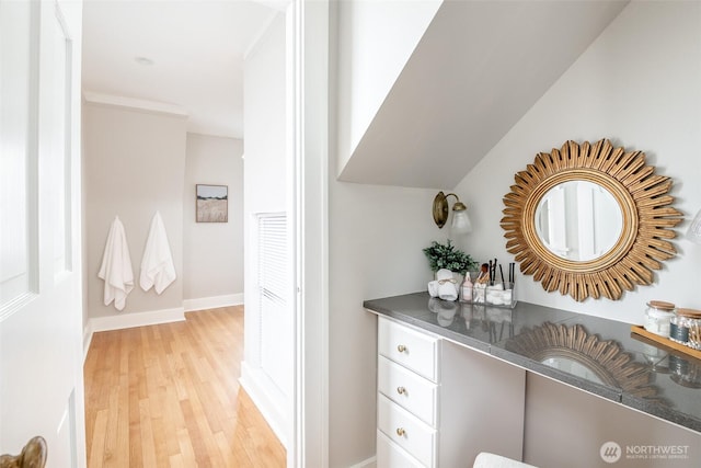 interior space with wood finished floors and baseboards