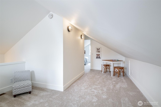 bonus room with lofted ceiling, visible vents, baseboards, and carpet floors