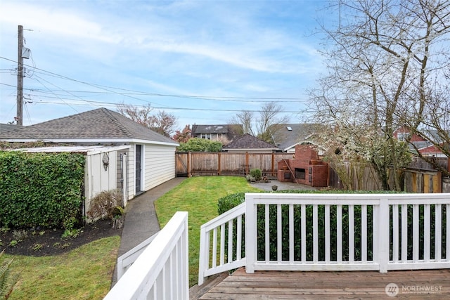 wooden deck with a yard and a fenced backyard