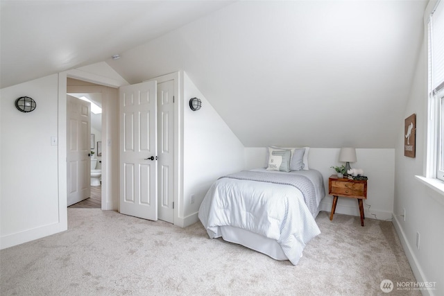 bedroom with lofted ceiling, carpet flooring, and baseboards