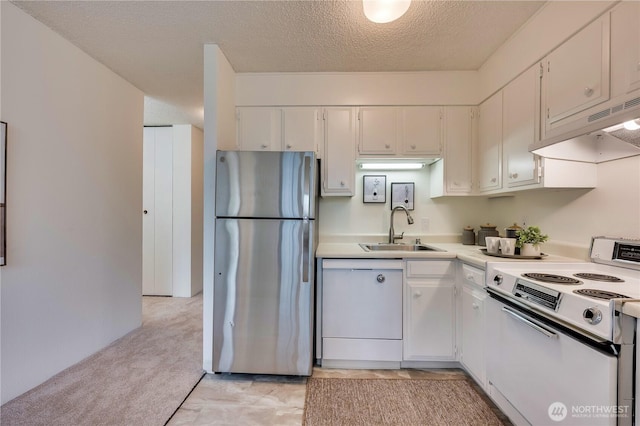 kitchen with under cabinet range hood, light colored carpet, light countertops, white appliances, and a sink