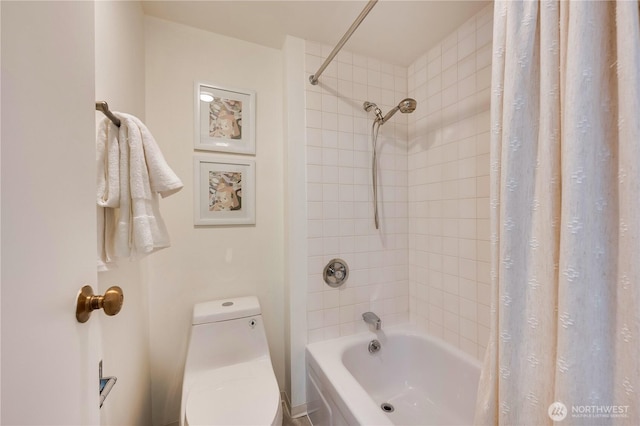 bathroom with toilet and shower / bath combo