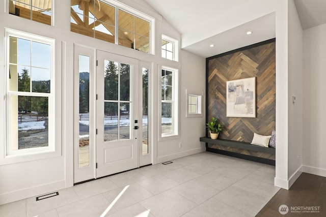 entryway with visible vents, an accent wall, baseboards, recessed lighting, and light tile patterned flooring