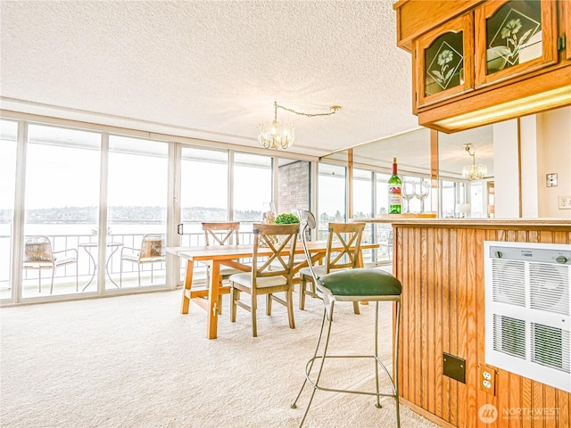 sunroom / solarium featuring a notable chandelier