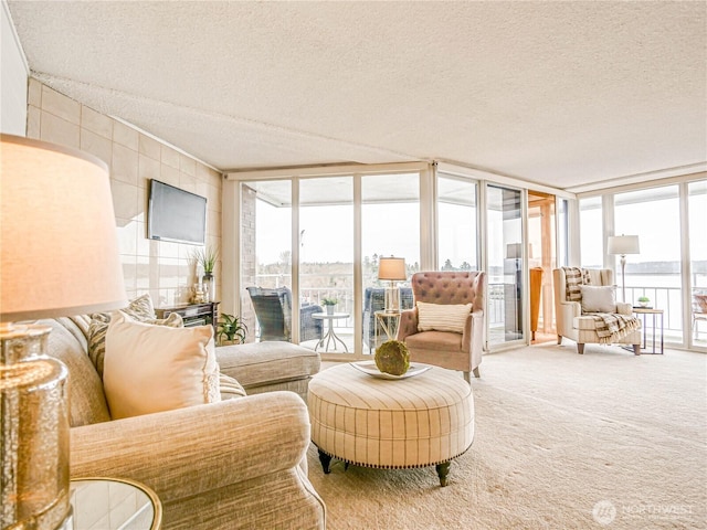 living room with a wall of windows, carpet flooring, and plenty of natural light