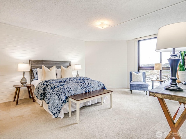 bedroom with a textured ceiling, carpet floors, and expansive windows