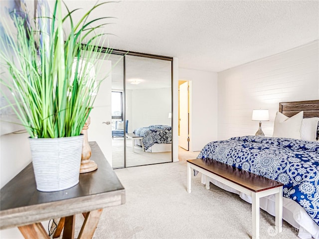 carpeted bedroom with a textured ceiling