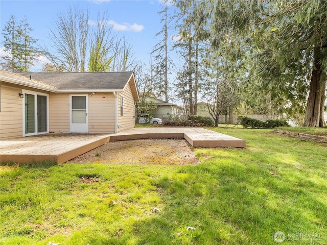 view of yard featuring a deck and fence