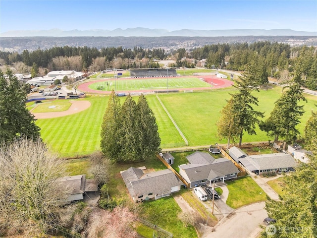 drone / aerial view featuring a mountain view and a forest view