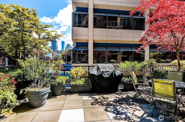 rear view of house with a city view and a patio