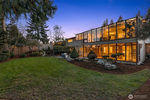 back of property featuring a patio area, a yard, and fence