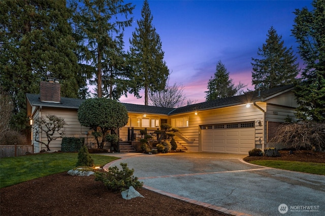 ranch-style home with a chimney, driveway, an attached garage, and fence