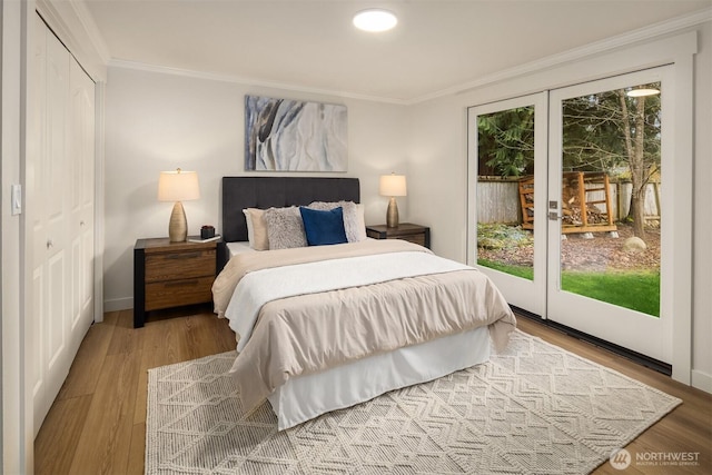 bedroom featuring multiple windows, wood finished floors, and crown molding