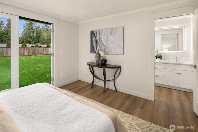 bedroom with baseboards, wood finished floors, ornamental molding, and access to exterior