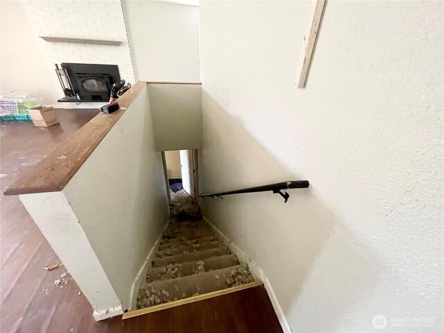 stairs featuring baseboards and wood finished floors