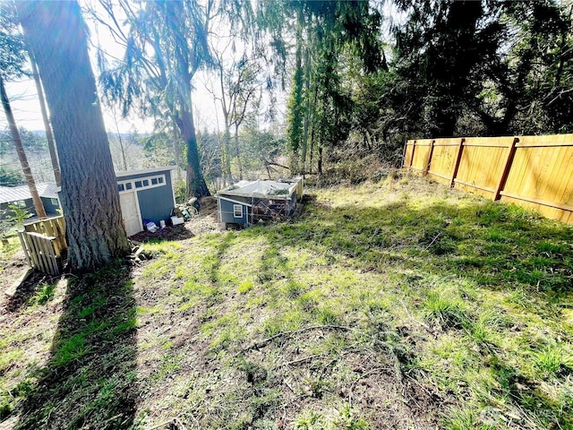 view of yard with an outdoor structure and fence