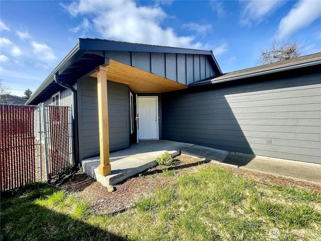 view of home's exterior featuring fence and board and batten siding