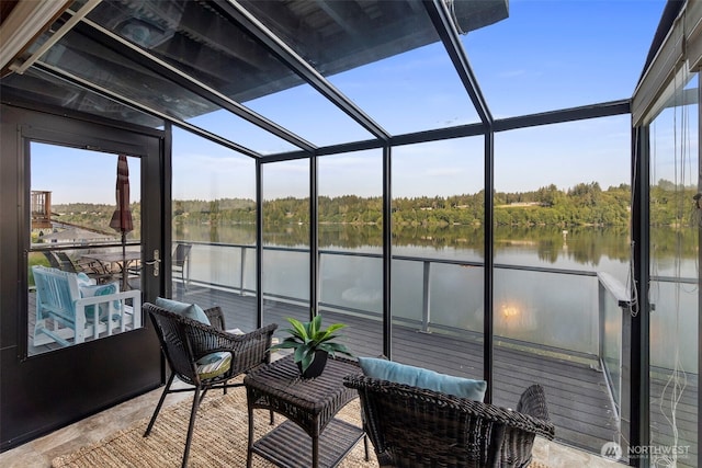 sunroom / solarium featuring a water view