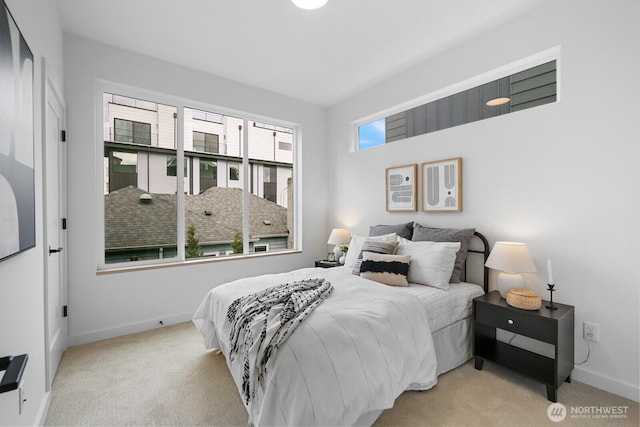 bedroom with baseboards and carpet floors