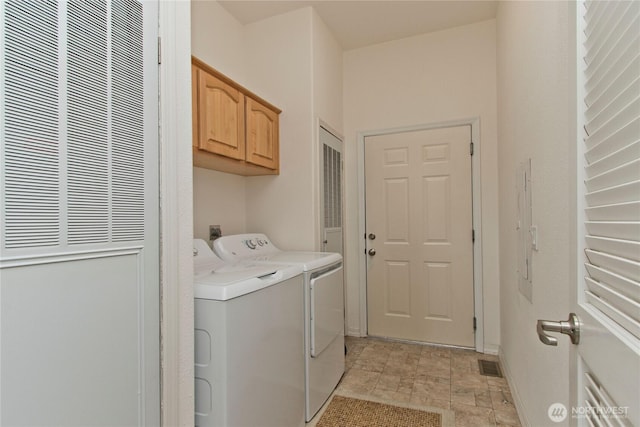 washroom featuring visible vents, separate washer and dryer, and cabinet space