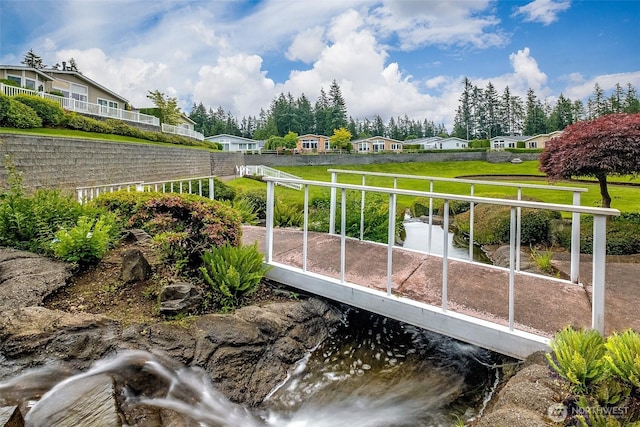 exterior space featuring a water view and a lawn