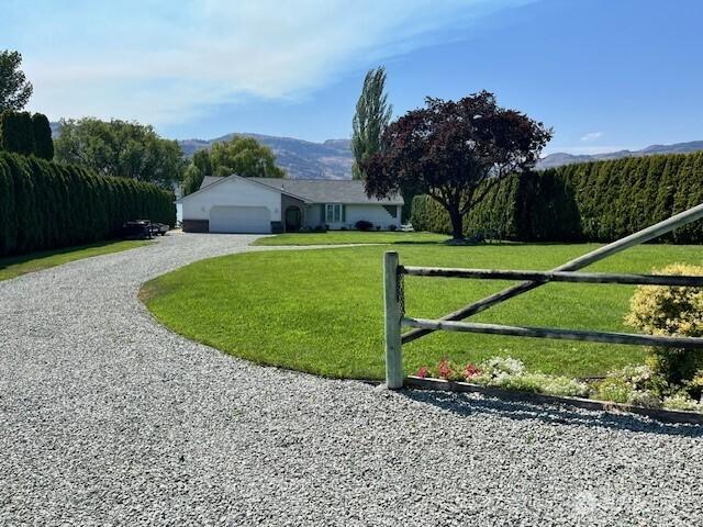 exterior space featuring fence and a lawn