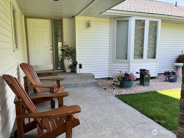 property entrance with roof with shingles