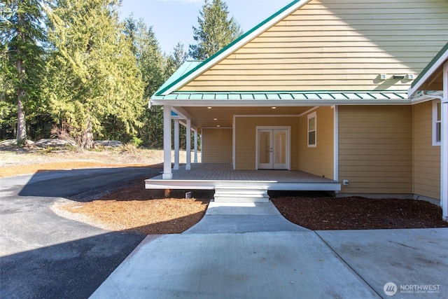 doorway to property with a standing seam roof, metal roof, and french doors