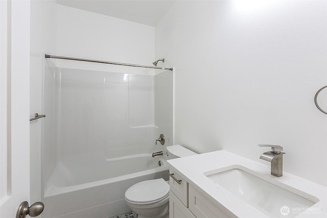 bathroom featuring vanity, toilet, and bathing tub / shower combination