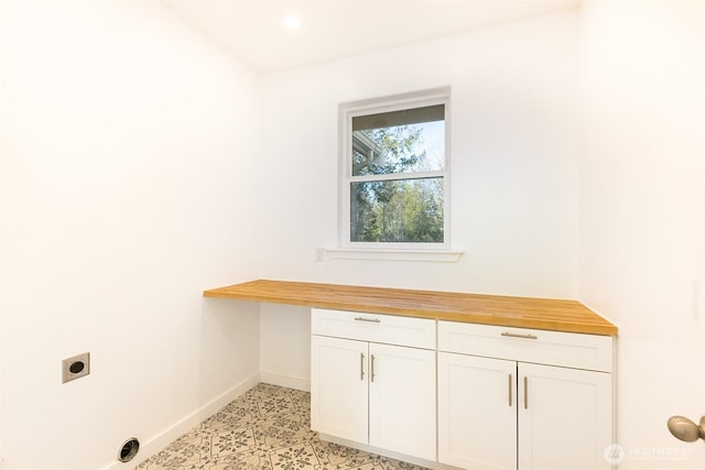 washroom featuring electric dryer hookup and baseboards