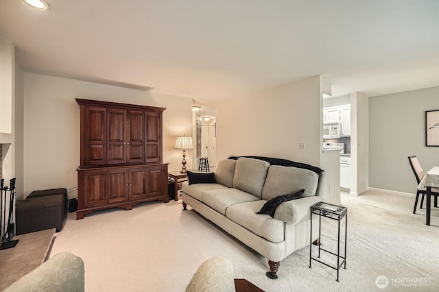 living room with light colored carpet and baseboards