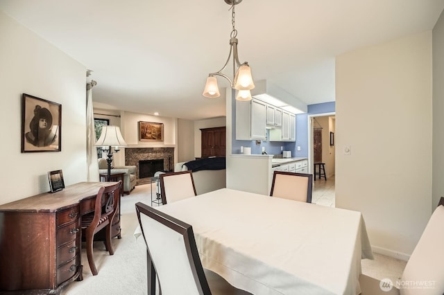 dining space with light carpet and a fireplace