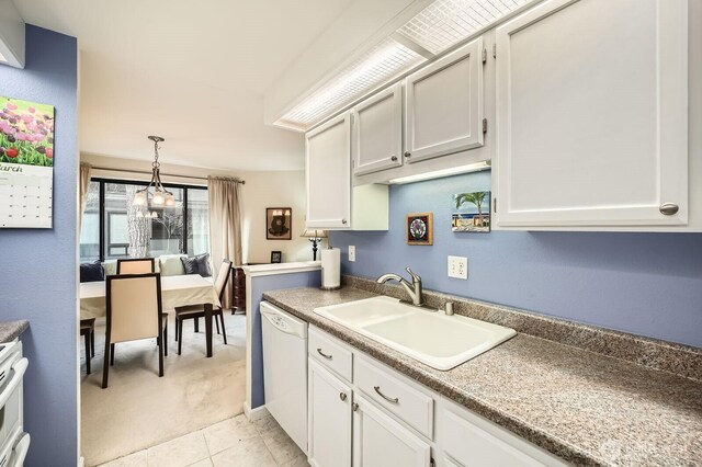 kitchen featuring pendant lighting, a sink, white cabinetry, white dishwasher, and light tile patterned floors