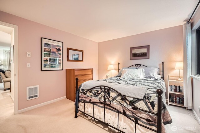 bedroom featuring light carpet, visible vents, and baseboards